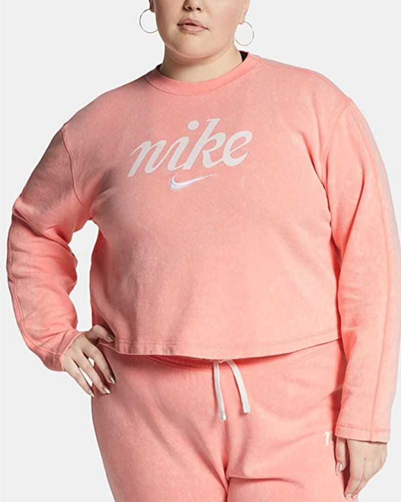 Front of a model wearing a size 3X Nike Women's Plus Sportswear Cotton Cropped Sweatshirt Pink Size 3X in Pink by Nike. | dia_product_style_image_id:313814